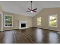 Bright living room featuring hardwood floors and a fireplace at 5394 Muirwood Pl, Powder Springs, GA 30127