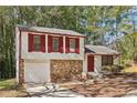 House with stone and white siding, red shutters at 5035 Fairforest Dr, Stone Mountain, GA 30088