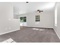Bright living room featuring carpet, ceiling fan and sliding glass doors at 124 Silver Fox Trl, Dallas, GA 30157