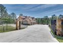 Automatic gate opens to a large home with a three-car garage at 187 Fontaine Sw Rd, Mableton, GA 30126