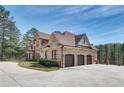 Three-car garage with brick and stone exterior at 187 Fontaine Sw Rd, Mableton, GA 30126