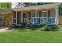 Inviting front porch with teal chairs and lush landscaping at 3894 Dollar Cir, Suwanee, GA 30024