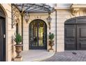 Elegant entryway with ornate iron door and planters at 2288 Peachtree Nw Rd # 6, Atlanta, GA 30305