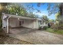Ranch house features carport, landscaping, and a green front door at 2210 Rhinehill Se Rd, Atlanta, GA 30315