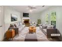 Virtually staged living room with fireplace and access to deck at 2988 Woodrow Mnr, Lithonia, GA 30038