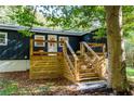 Elevated wooden deck with stairs leading to backyard at 140 Walker Woods Dr, Carrollton, GA 30116