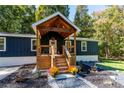 Newly renovated home with covered porch and landscaped yard at 140 Walker Woods Dr, Carrollton, GA 30116