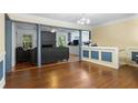 Bright dining room with hardwood floors and a view into the kitchen at 422 White Oak Nw Dr, Lilburn, GA 30047