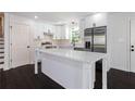 Modern kitchen with white cabinets, stainless steel appliances, and quartz countertops at 504 Milligan Dr, Stone Mountain, GA 30083