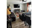 Living room featuring black leather furniture, wood flooring, and a large TV at 3035 Chris Cir, Villa Rica, GA 30180