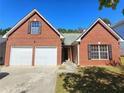 Brick home with a two-car garage and well-maintained lawn at 1734 Spring Hill Cv, Lithonia, GA 30058