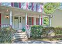 Inviting front porch with white railings and landscaping at 2459 Jacks View Ct, Snellville, GA 30078