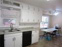 Kitchen with white cabinets, granite counters, and tile floor at 2107 Briarwood Ct, Snellville, GA 30078