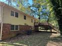 Rear exterior view with a deck and stairs at 6883 Lakeshore Dr, Douglasville, GA 30135