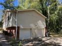 Two-car garage with white doors at 6883 Lakeshore Dr, Douglasville, GA 30135