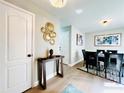 Elegant dining room featuring a dark wood table, six black chairs, and modern wall art at 430 Thornbush Trce, Lawrenceville, GA 30046