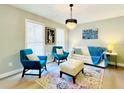 Cozy living room with teal armchairs, a beige sofa, and an eye-catching rug at 430 Thornbush Trce, Lawrenceville, GA 30046