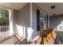 Front porch with rocking chairs and grey siding at 110 Wildcat Bluff Ct, Lawrenceville, GA 30043