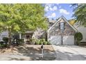 Brick house exterior with two-car garage and landscaped yard at 911 Queensbrooke Way, Mableton, GA 30126