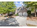 Brick house with two-car garage and landscaping at 911 Queensbrooke Way, Mableton, GA 30126