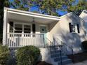 Updated brick ranch with a welcoming front porch, new paint, and attractive landscaping at 411 Greencove Se Ln, Atlanta, GA 30316