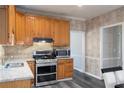 Eat-in kitchen with granite counters, stainless steel appliances, and wood cabinets at 350 Wilma Sw Ct, Atlanta, GA 30331