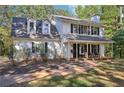 Two-story white house with black shutters and a front porch at 4012 Union Church Sw Rd, Stockbridge, GA 30281