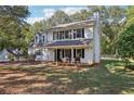 Two-story white house with black shutters and a front porch at 4012 Union Church Sw Rd, Stockbridge, GA 30281