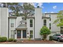 Gray townhome with double doors and a car parked in front at 1053 Riverbend Club Se Dr, Atlanta, GA 30339