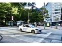 Street view of a city block with cars and pedestrians at 32 Peachtree Nw St # 1006, Atlanta, GA 30303