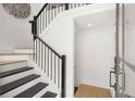 Modern staircase with dark wood steps and black railing at 201 New St # 2201-9, Decatur, GA 30030