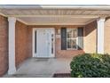 Brick front entry with white door and black shutters at 4011 Lafayette Way, Loganville, GA 30052