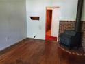 Living room with hardwood floors, brick fireplace, and wood stove at 3102 Mckenzie Rd, Atlanta, GA 30344