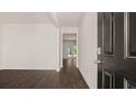 Bright entryway with dark front door and view into the living area at 576 Whitman (2020) Ln, Stockbridge, GA 30281