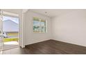 Spacious front room with dark hardwood floors and an exterior door at 576 Whitman (2020) Ln, Stockbridge, GA 30281