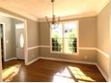 Bright dining room with hardwood floors, crown molding, and chandelier at 1965 Tyler Trce, Lawrenceville, GA 30043