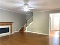 Living room with hardwood floors, fireplace, and staircase at 1965 Tyler Trce, Lawrenceville, GA 30043