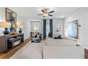Bright living room featuring hardwood floors, comfy sectional sofa, and a modern fireplace at 1916 School House Ln, Temple, GA 30179