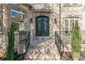Ornate double front doors and brick entryway with iron railings at 3939 Perry Pass, Lithonia, GA 30038