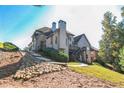 House exterior showcasing a stone retaining wall and deck at 3939 Perry Pass, Lithonia, GA 30038