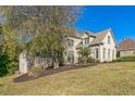 Brick house with a tree in the front yard and a large lawn at 3939 Perry Pass, Lithonia, GA 30038