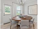 Bright dining room with round wooden table and gray chairs at 402 Beacon Way, Villa Rica, GA 30180