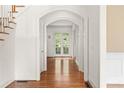 Elegant hallway with hardwood floors and arched doorways at 2865 Payton Oaks Ne Dr, Atlanta, GA 30345