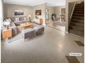 Virtually staged living room with tile floors and modern furniture at 125 Cainwood W Ct, Atlanta, GA 30349