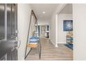 Bright entryway with modern shelving unit and hardwood floors at 1261 Arnhem Dr, Hampton, GA 30228