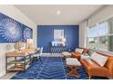 Home office with blue accent wall, leather chairs and desk at 1261 Arnhem Dr, Hampton, GA 30228