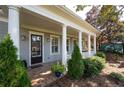 Home features a welcoming front porch with columns at 244 Rope Mill Rd, Woodstock, GA 30188