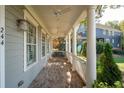 Spacious front porch with brick flooring and ceiling fan at 244 Rope Mill Rd, Woodstock, GA 30188
