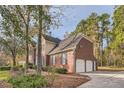 Two-story house with a three-car garage and landscaping at 2582 Fairview Ln, Jonesboro, GA 30236