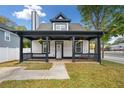 A cozy front porch with black railing and hanging flower baskets at 520 Mary Sw St, Atlanta, GA 30310